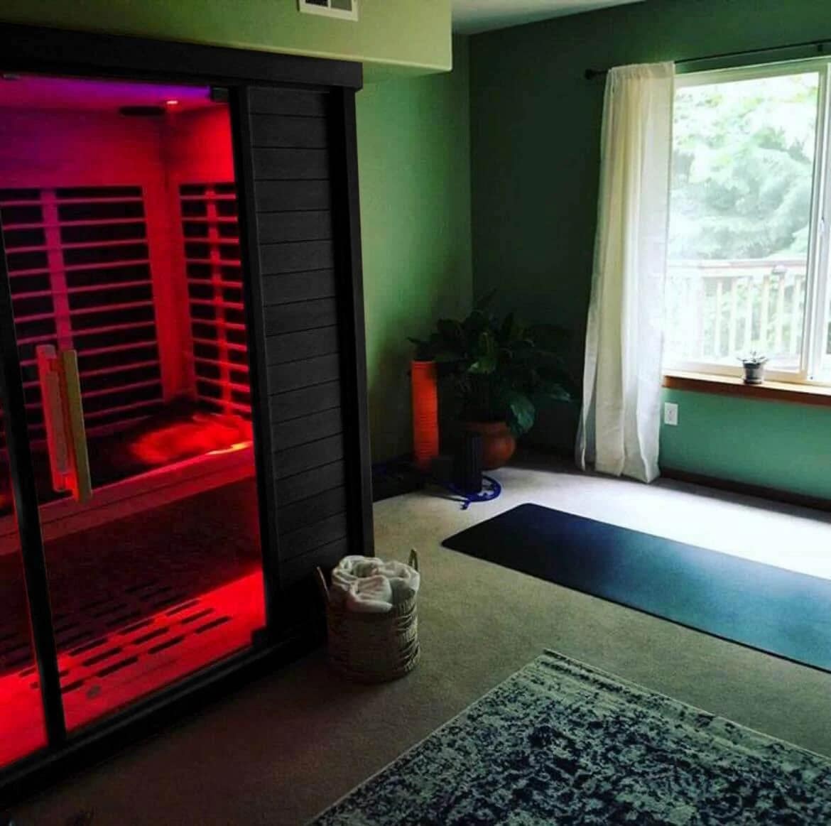 Sun Home Equinox sauna in a home studio beside a yoga mat
