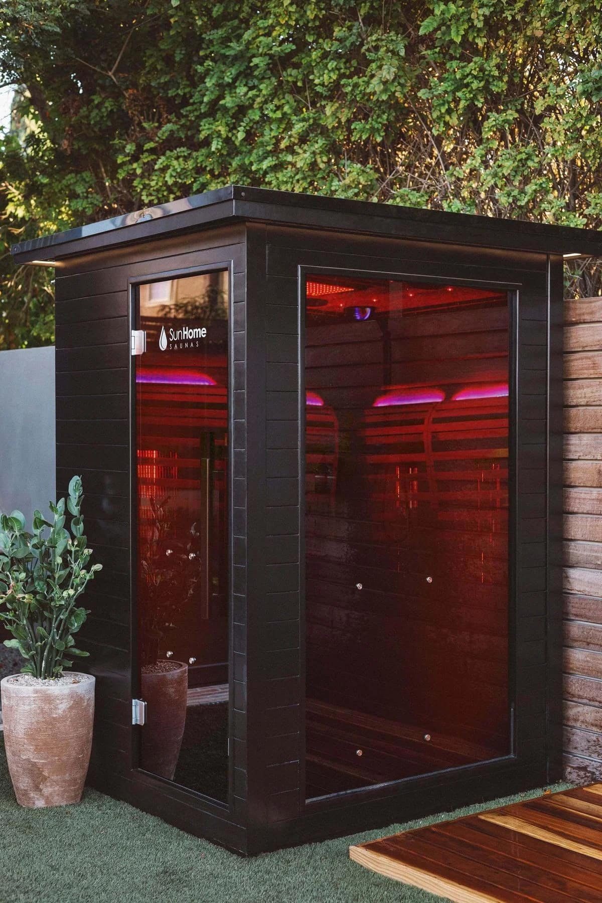 Sun Home Luminar 2-Person on a patio with colored lights glowing through the glass